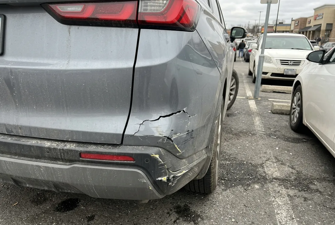 Scraped car bumper being repaired at a body shop in Upland, CA