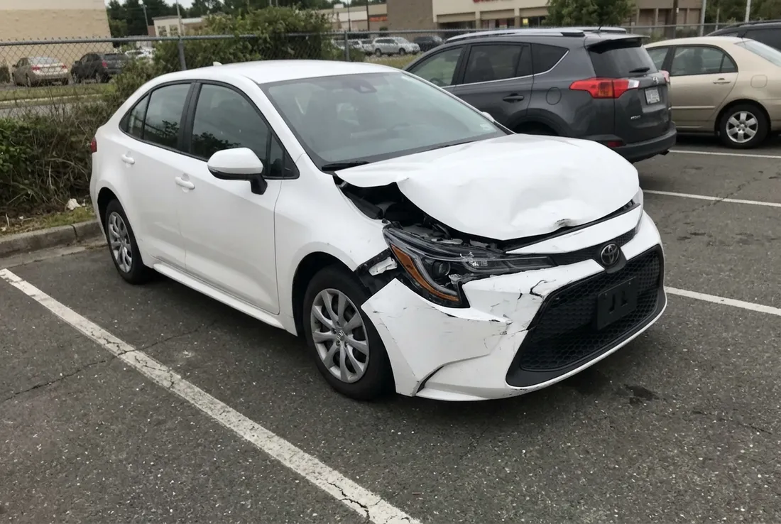 Car with front end collision damage being repaired in Upland, CA